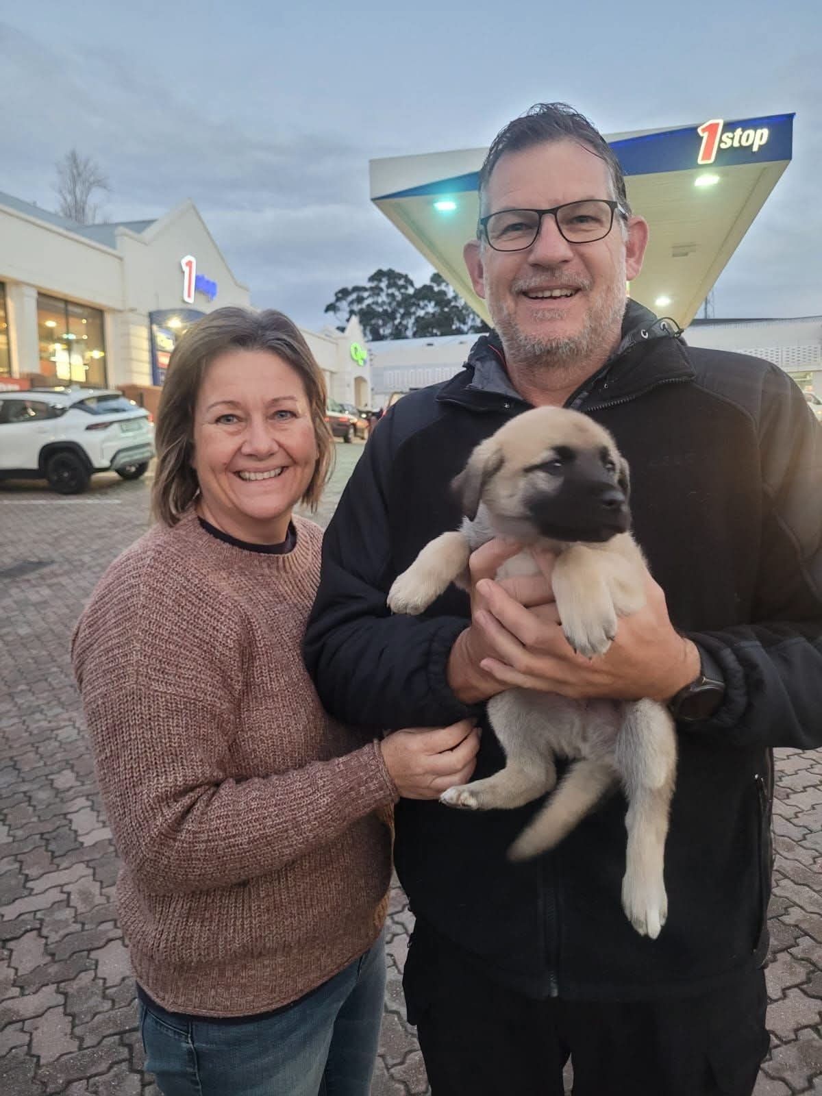 A couple collecting their puppy partway along the route