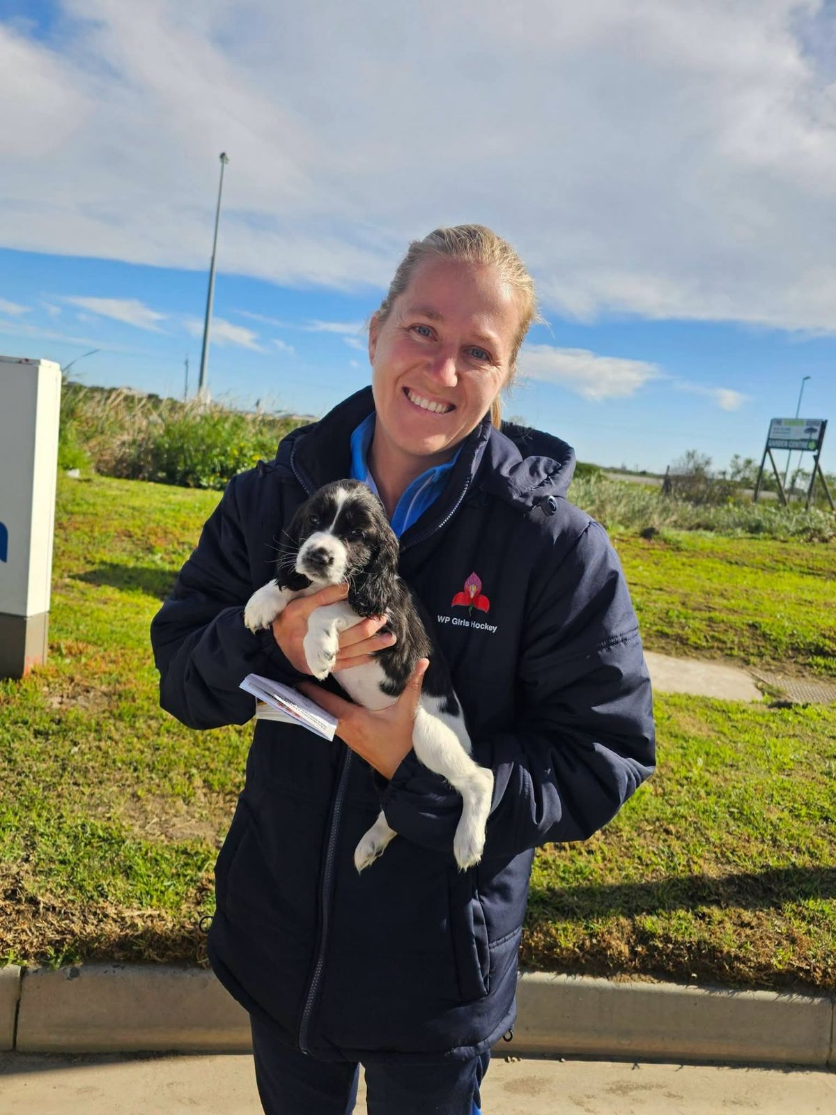 A puppy held safely before the final stretch of the trip
