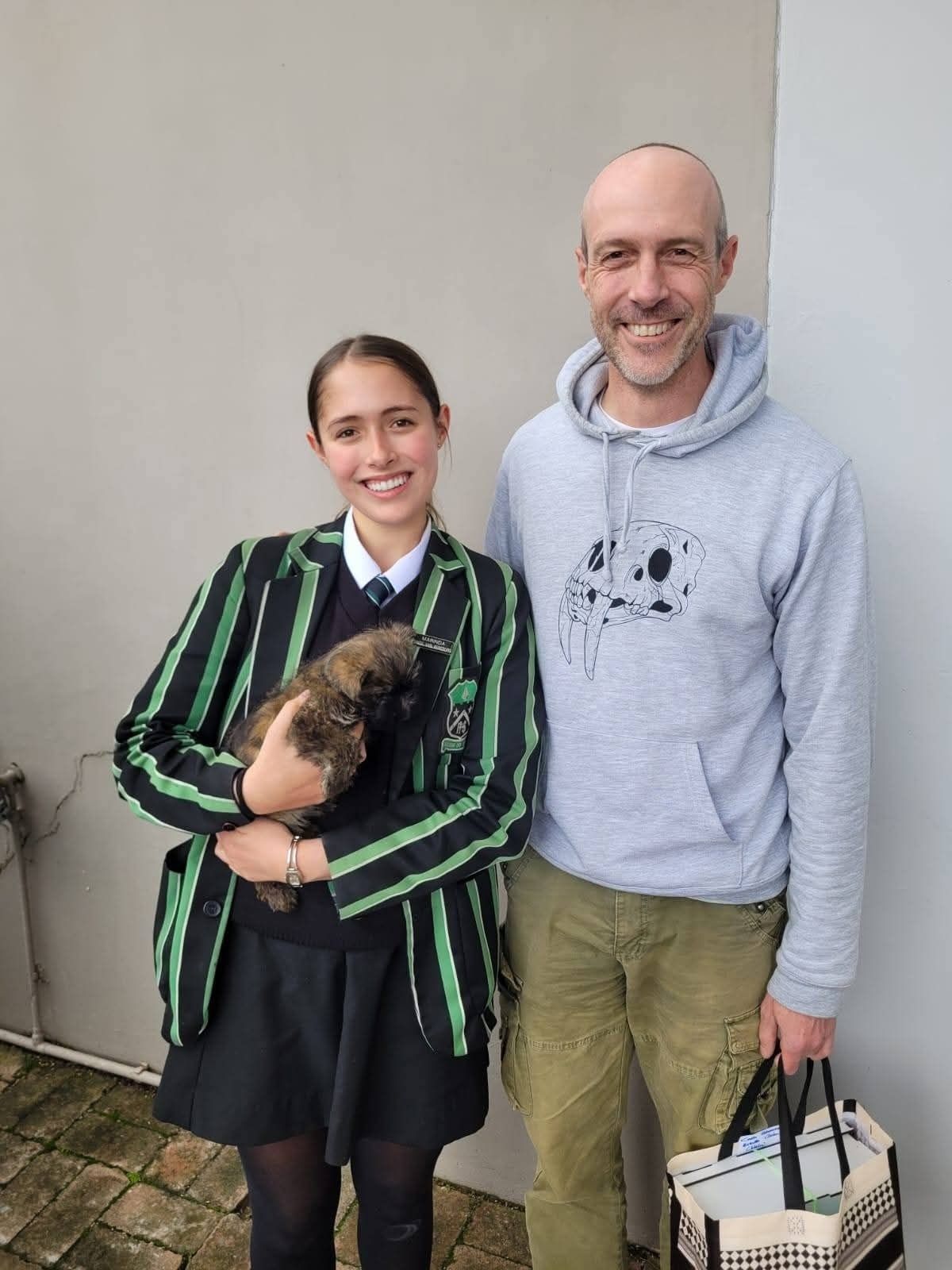 A family collecting their puppy at the front door