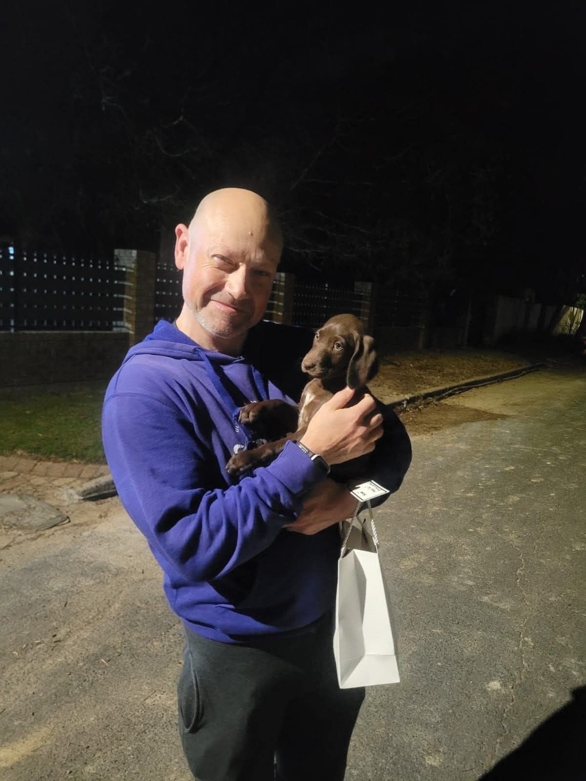 An evening handover, puppy and paperwork together
