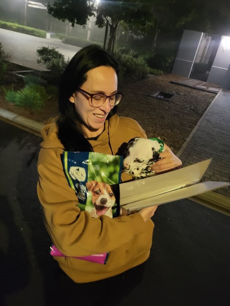 A puppy carried indoors in her travel box