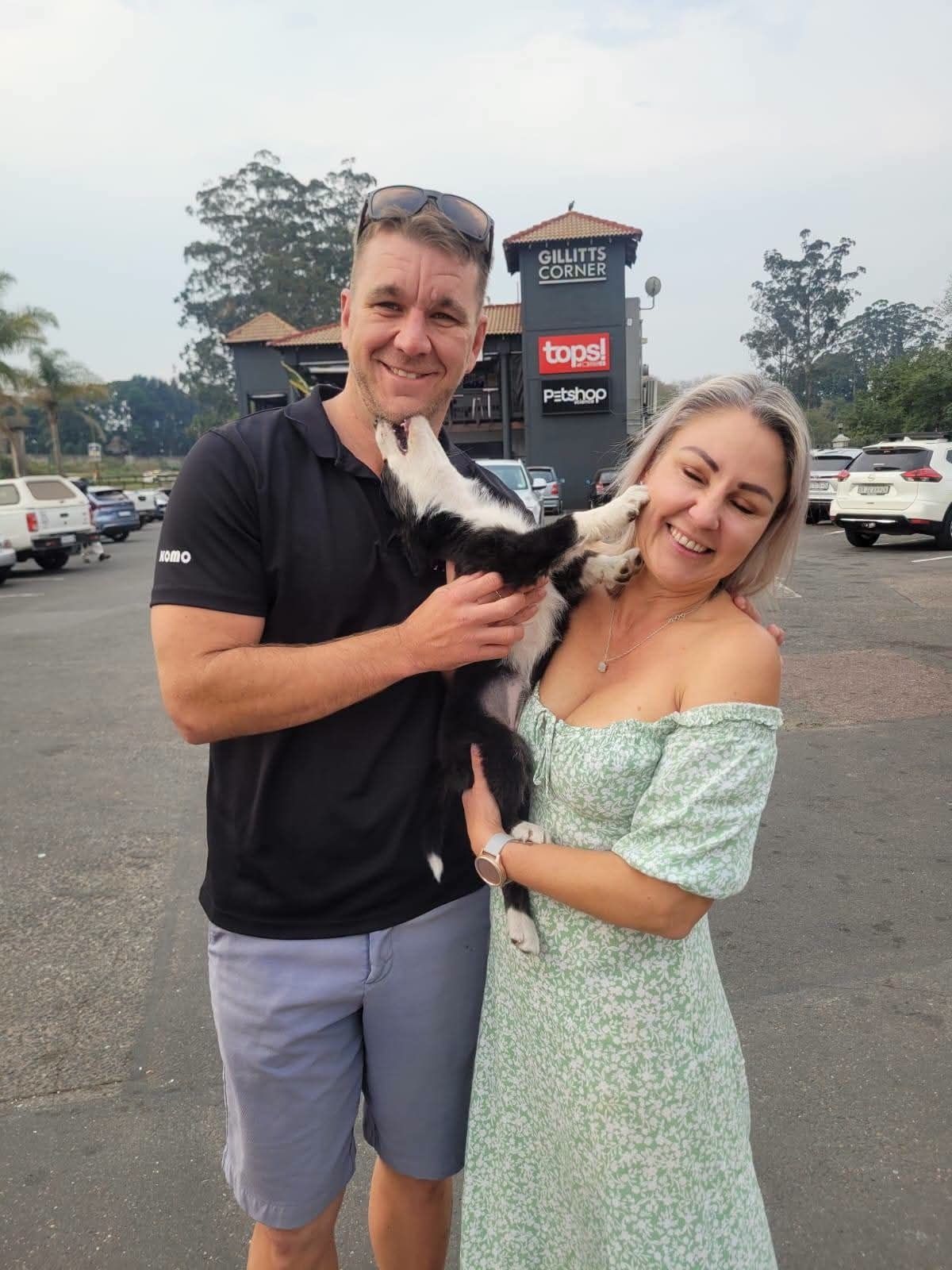 A couple outdoors with their small dog on arrival